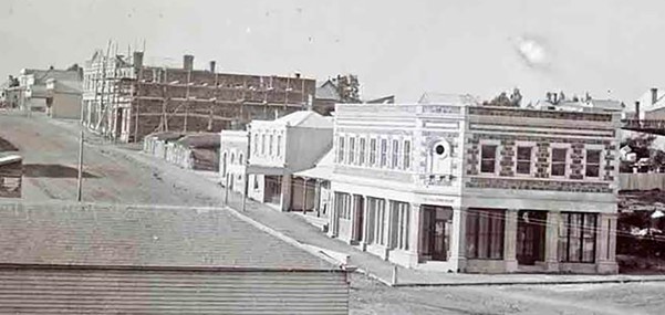 Richard Turnbulls Stone Store up the hill on the left On the corner is Richard Turnbulls shop that was rebuilt in stone after the 1868 fire Alfred Charles Barker Canterbury Museum ID 1357