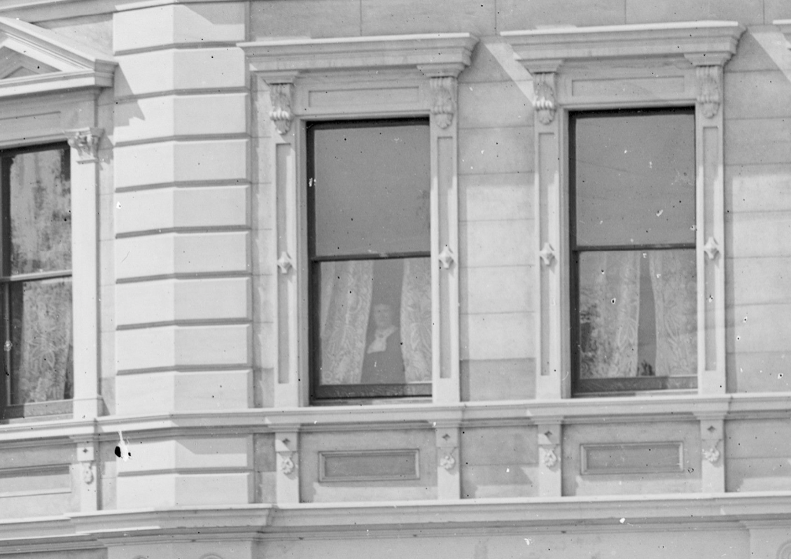 Woman in the window at Ship Hotel on Strathallan St Timaru Te Papa 014591 Crop